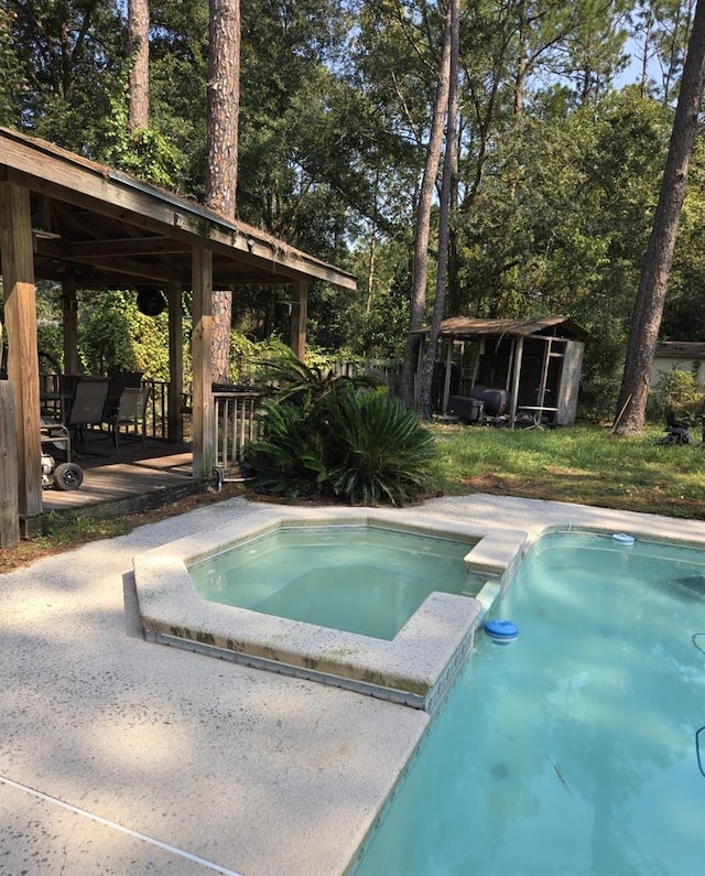 view of pool with a gazebo and a pool with connected hot tub