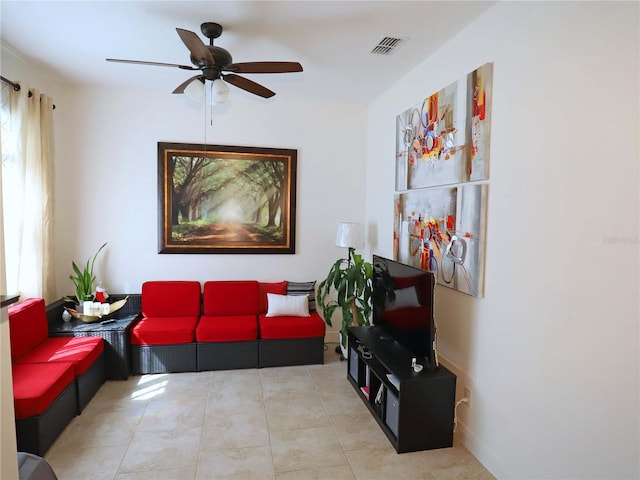 living room featuring light tile patterned floors and ceiling fan