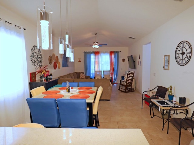 dining space featuring light tile patterned floors and ceiling fan