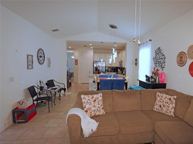 tiled living room featuring vaulted ceiling