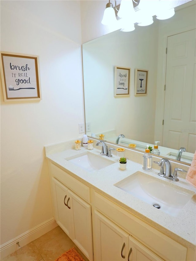 bathroom with tile patterned flooring, a notable chandelier, and vanity