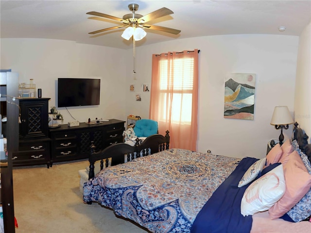 carpeted bedroom featuring ceiling fan and vaulted ceiling