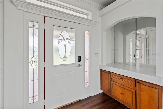 foyer with crown molding and dark hardwood / wood-style floors