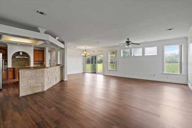 unfurnished living room with ornamental molding, sink, ceiling fan with notable chandelier, and dark hardwood / wood-style flooring