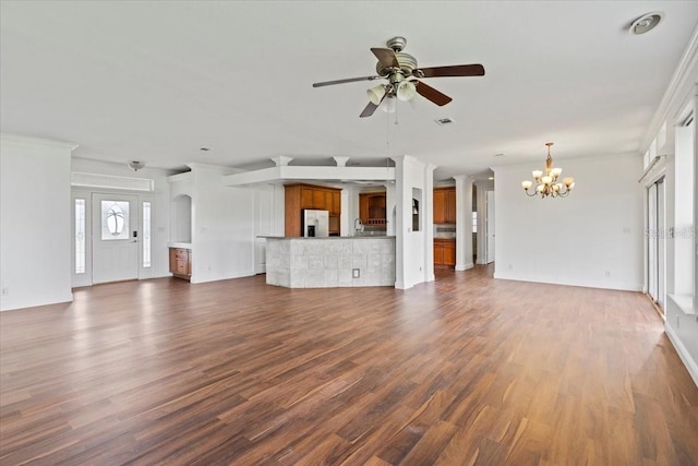 unfurnished living room featuring ornamental molding, hardwood / wood-style floors, and ceiling fan with notable chandelier