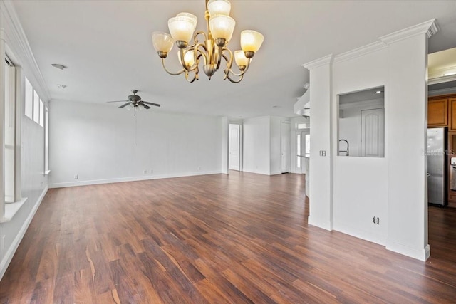 unfurnished living room featuring ornamental molding, ceiling fan with notable chandelier, and dark hardwood / wood-style flooring