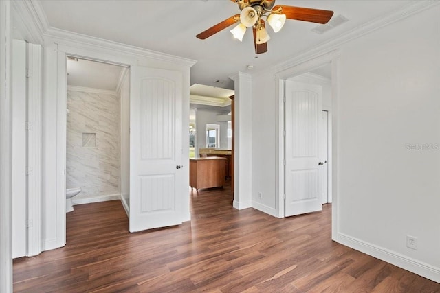 unfurnished bedroom featuring dark wood-type flooring, crown molding, connected bathroom, and ceiling fan