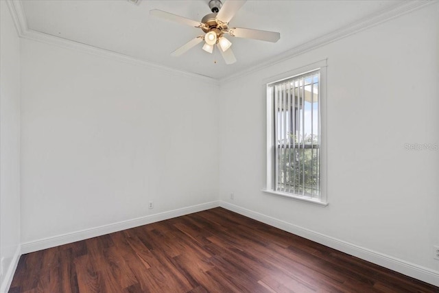 spare room featuring plenty of natural light, dark hardwood / wood-style floors, crown molding, and ceiling fan