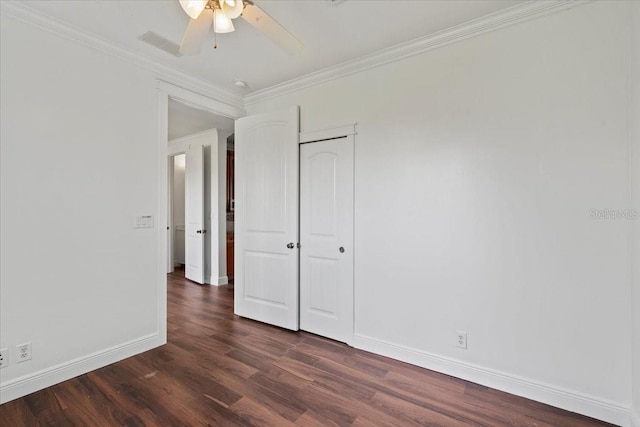 interior space with ceiling fan, a closet, crown molding, and dark wood-type flooring