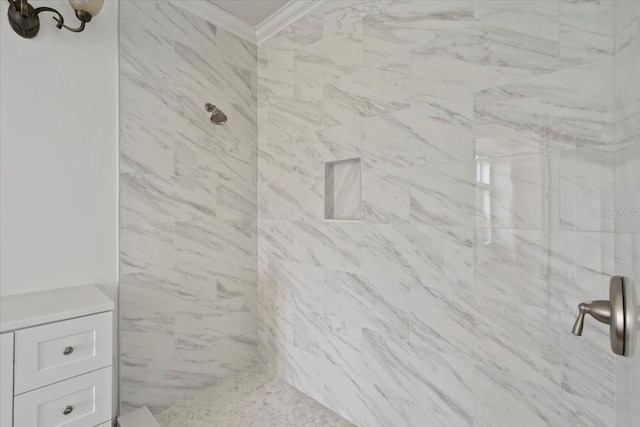 bathroom featuring ornamental molding and tiled shower