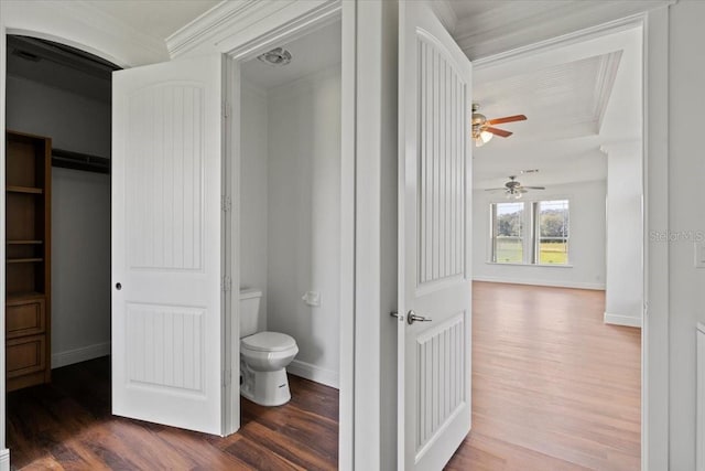 bathroom featuring wood-type flooring, ceiling fan, crown molding, and toilet