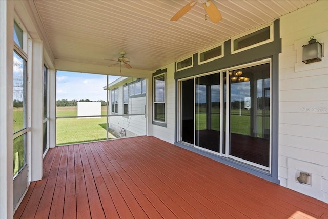 unfurnished sunroom featuring ceiling fan