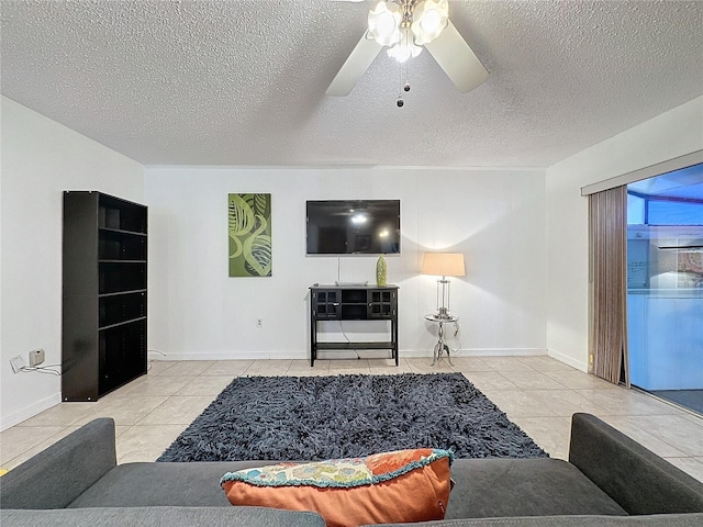 living room featuring ceiling fan, a textured ceiling, and light tile patterned floors