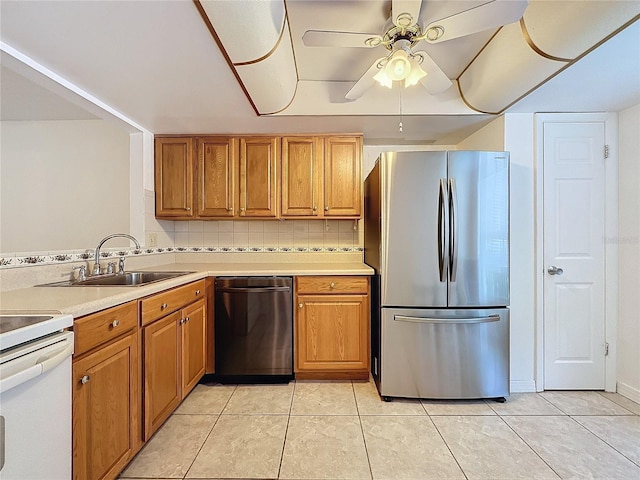 kitchen featuring ceiling fan, light tile patterned flooring, sink, backsplash, and appliances with stainless steel finishes