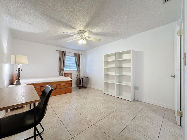 tiled office featuring ceiling fan and a textured ceiling