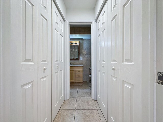 corridor featuring light tile patterned flooring