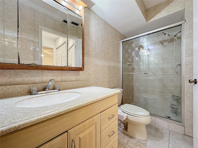 bathroom with walk in shower, toilet, vanity, and tile walls