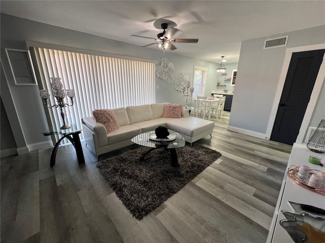 living room featuring ceiling fan and hardwood / wood-style flooring