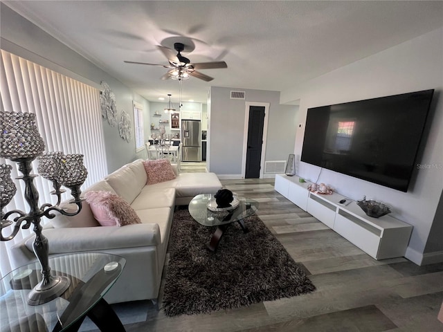 living room with hardwood / wood-style floors and ceiling fan