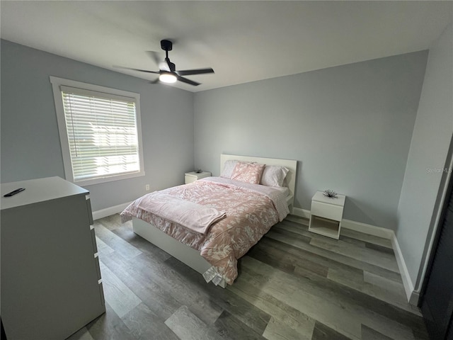 bedroom featuring ceiling fan and dark hardwood / wood-style floors