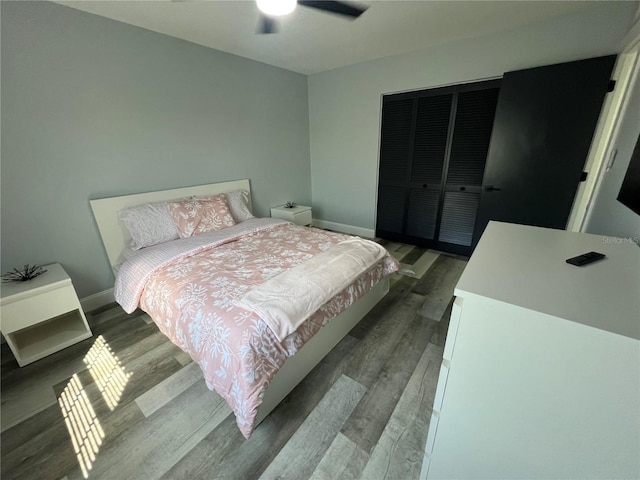 bedroom featuring hardwood / wood-style flooring and ceiling fan