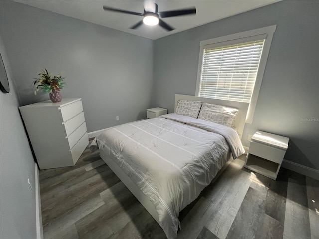 bedroom with dark wood-type flooring and ceiling fan