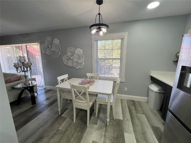 dining room with wood-type flooring and a notable chandelier