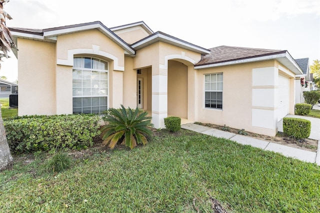 view of front of property with a garage and a front yard