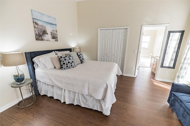 bedroom with dark wood-type flooring and a closet