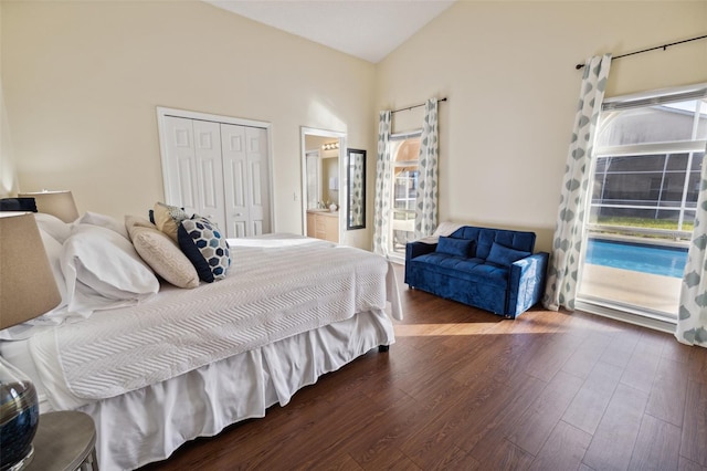 bedroom featuring ensuite bath, a closet, dark hardwood / wood-style floors, and access to outside