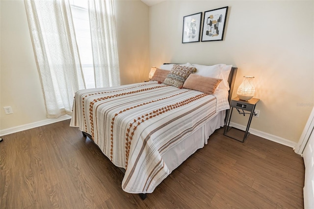 bedroom with dark hardwood / wood-style flooring