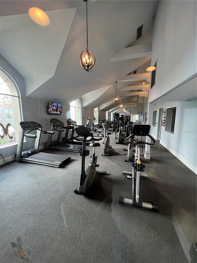 workout area featuring lofted ceiling and plenty of natural light