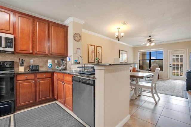 kitchen featuring light tile patterned floors, sink, kitchen peninsula, appliances with stainless steel finishes, and ceiling fan with notable chandelier