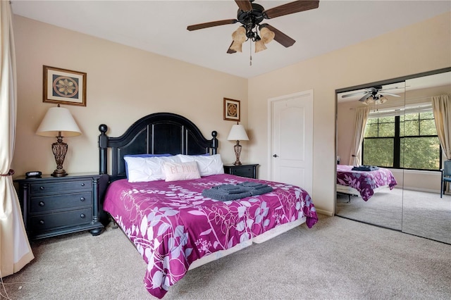 carpeted bedroom with ceiling fan and a closet