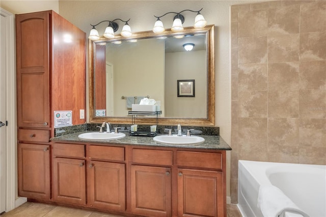 bathroom featuring a bathing tub, tile patterned flooring, and vanity