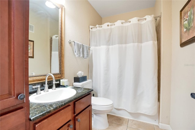 bathroom with tile patterned flooring, vanity, and toilet