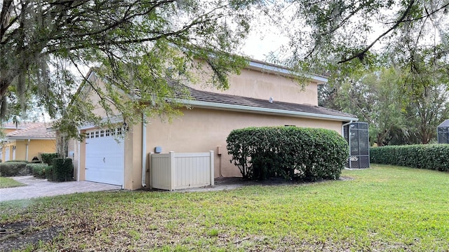 view of property exterior with a garage and a yard