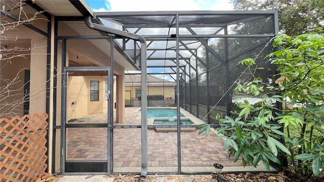 view of swimming pool featuring a lanai, an in ground hot tub, and a patio area