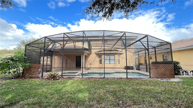 back of house featuring a lanai and a yard