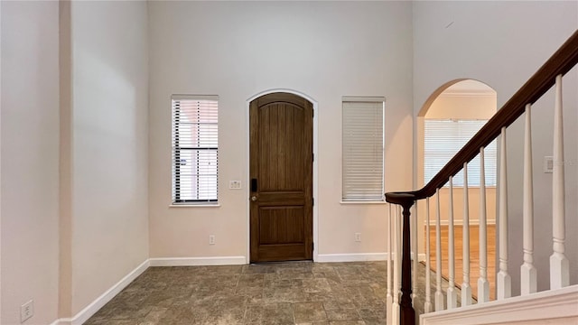 foyer entrance with a towering ceiling