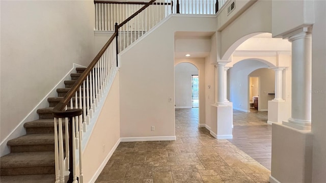 stairs with hardwood / wood-style floors and a high ceiling