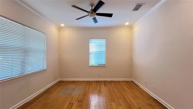 empty room featuring hardwood / wood-style floors, ceiling fan, and ornamental molding