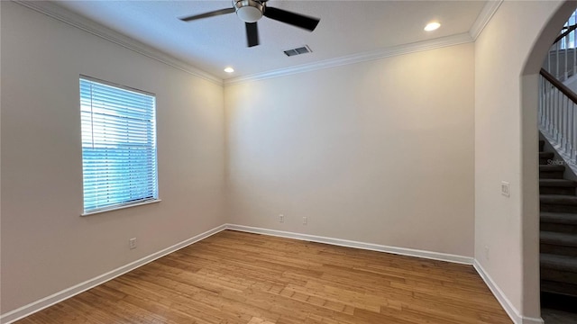 unfurnished room featuring light hardwood / wood-style flooring, ceiling fan, and crown molding