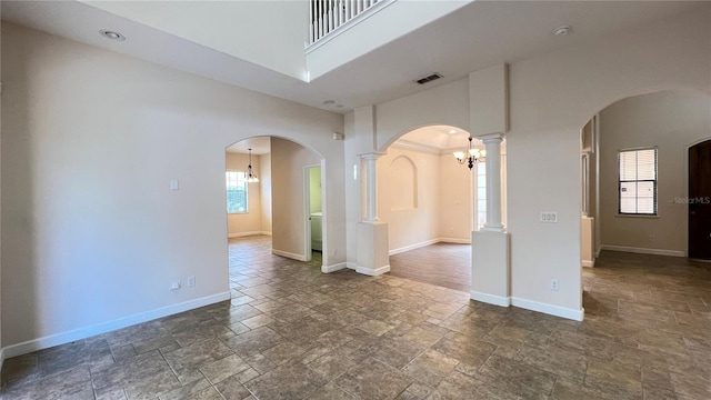 spare room featuring ornate columns