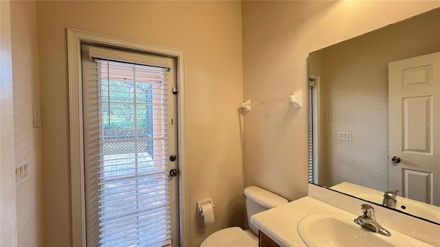 bathroom featuring toilet and vanity