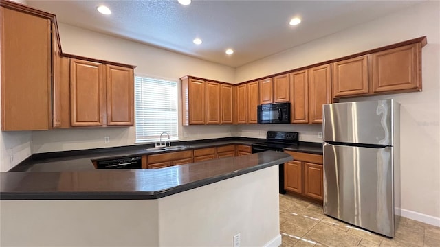 kitchen with black appliances, kitchen peninsula, and sink