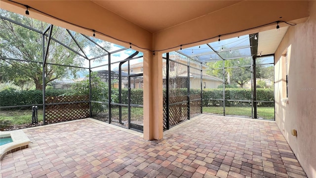 view of patio with glass enclosure