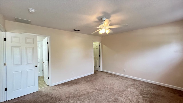 unfurnished bedroom with a textured ceiling, ceiling fan, and carpet floors