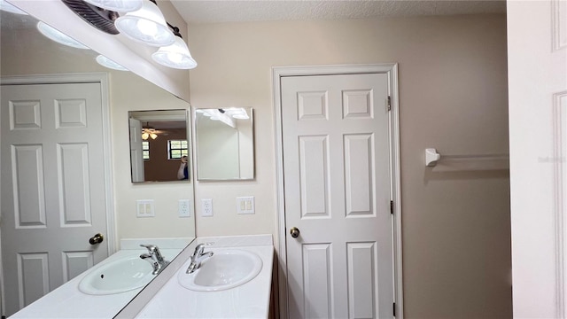 bathroom with vanity, a textured ceiling, and ceiling fan