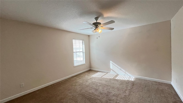 carpeted spare room with ceiling fan and a textured ceiling